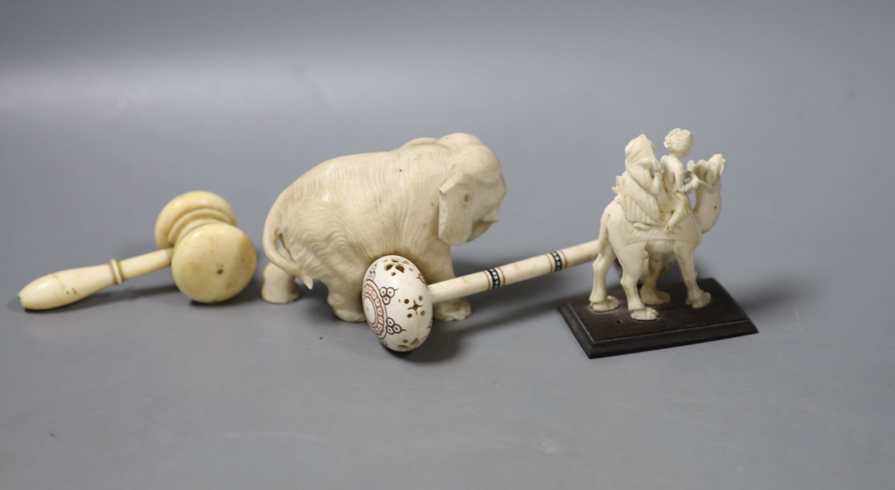 A Japanese Ivory okimono of an elephant, signed, an ivory gavel (incomplete) and two other Ivory carvings, 19th/early 20th century